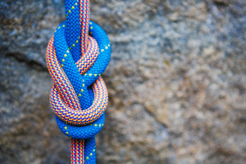 eight rope knot on rocky background - obrazy, fototapety, plakaty