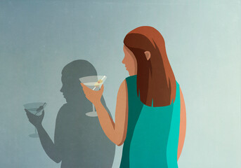 Shadow of woman with martini at wall
