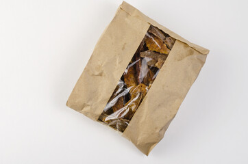 Pet treats in a brown paper bag with a window. Kraft bag with pi