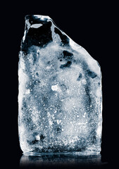 Crystal clear natural ice block on a black reflective surface. Clipping path included.