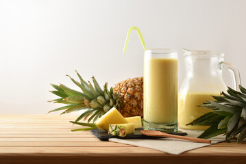 Glass and jug with pineapple juice isolated background.
