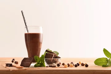 Foto op Aluminium Glass with milk chocolate shake on wooden table isolated background © Davizro Photography