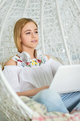 Portrait of beautiful cute girl using laptop at home