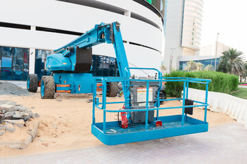 Lift and elevator hydraulic heavy machinery on the chassis with platform and basket at construction site.