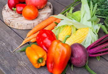 Harvest of colorful vegetables on a wooden background. Seasonal harvest in agriculture, vegetarian