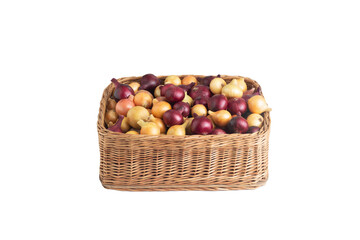 Multicolored yellow and red onions in a wicker basket on a white background, isolate, vegetable