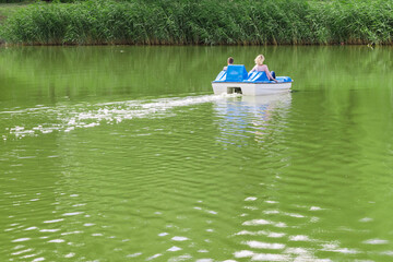 Fototapeta na wymiar A young couple in love is resting on a water bike. Rear view with a copy of the space below.
