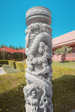 A stone pillar decorated with engraved dragons as totems for safety from evil spirits. The concept of Eastern and Chinese beliefs and traditions