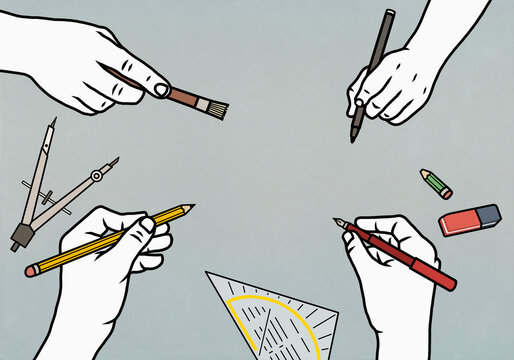 Creative hands holding writing devices
