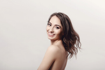 Fototapeta premium The beautiful girl is having a photo session in the studio in a night dress.