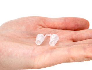 Anti-snoring device for nose in the palm of a person, close-up. Sleep problems