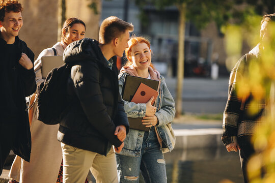 Smiling Girl Walking With Friends In High School