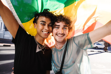 Smiling queer men celebrating gay pride outdoors - obrazy, fototapety, plakaty