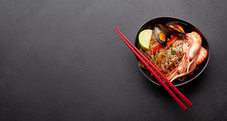 Wok with stir fried noodles, shrimps and vegetables