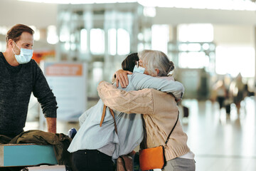 Senior woman welcoming her arriving daughter at airport