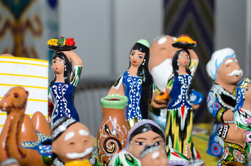 Traditional ceramic figurines of uzbek girls in national clothes