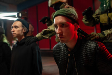 Men in military outfit arresting group of cyber criminals