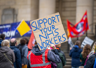 Support your NHS workers at protest rally holding home made placard sign to gain support for NHS key worker staff on march. - obrazy, fototapety, plakaty
