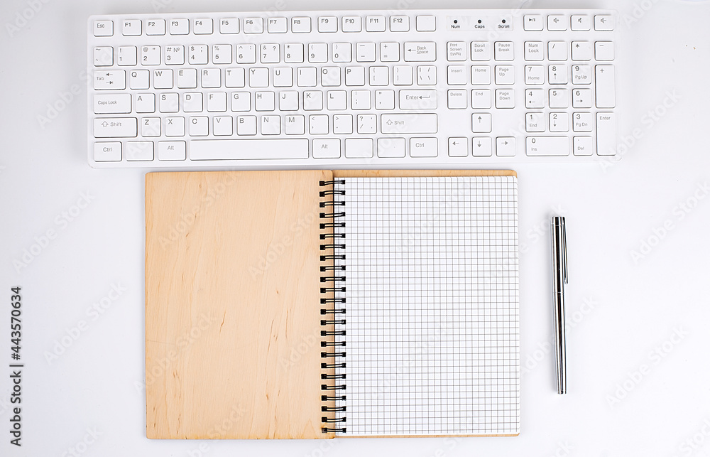 Aufkleber top view of white desk with keyboard and notebook. copy space