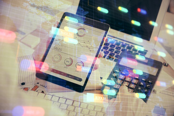 Double exposure of man's hand holding and using a digital device and data theme hologram drawing. Technology concept.