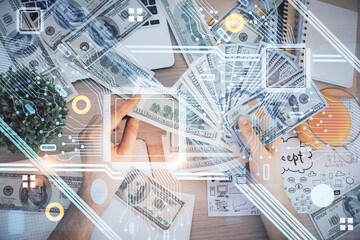 Multi exposure of technology drawing hologram and us dollars bills and man hands. Data concept
