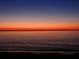 Fototapeta premium colorful sunrise over the beach at rehoboth beach, delaware, as seen from the henlopen hotel