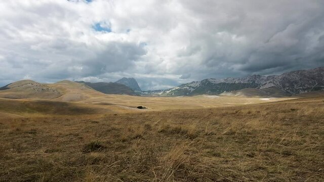 Campo Imperatore on a summer day with cloudy skies, a vast plateau located at 1800 meters above sea level in the center of the Gran Sasso National Park and Lega mounts. Plateau of the Abruzzo Apennine
