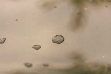 Close up macro view of rain drops on metal surface. 
