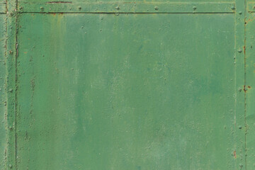 Green faded metal wall with metal stripes on the edges. Metal frame. 