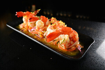 cook fresh big tiger prawn salad appetiser canapé with Thai spicy chilli sauce in dark background asian cocktail menu