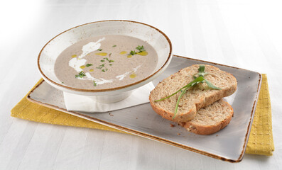 home made hot mushroom thick soup with French toast bread in white background western appetiser halal menu