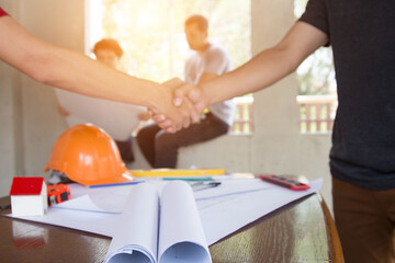 team Engineer and Architect consult projct with blueprint  at Construction Site