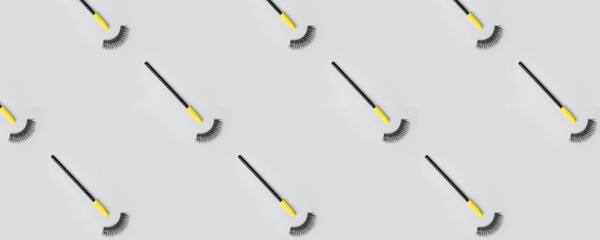 Set for eye lash extension on trendy gray background. Fake eyelashes, mascara brush, Beauty stylish...