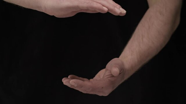 male hands on a black background