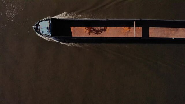 Top View Of A Empty Cargo Ship Traveling On The Oude Mass River At Barendrecht Town In Netherlands. aerial