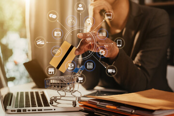 Hands holding credit card and using laptop in office home. Online shopping.