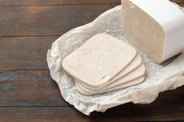 Cut chicken sausage slices on wooden table