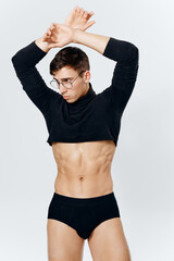 Fototapeta na wymiar a guy in shorts on a light background and a pumped-up torso sweater