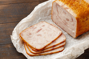 Cut chicken sausage slices on wooden table