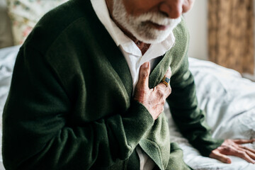 An elderly Indian man with heart problems - obrazy, fototapety, plakaty