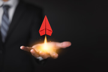 Businessman holding red paper plane, leadership, STARTUP business concept