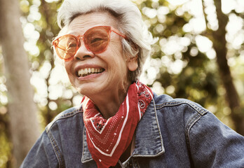 A cheerful female elderly in denim jacket