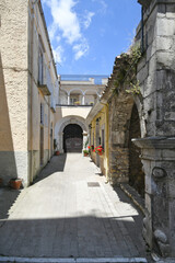 Obraz premium A narrow street between the old houses of Rocchetta Sant'Antonio, a medieval village in Puglia region, Italy.