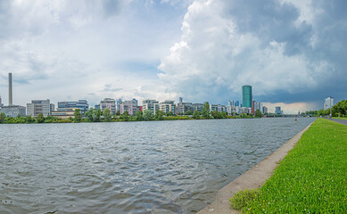 Fototapeta na wymiar View of the Frankfurt skyline from the banks of the Main River during an approaching thunderstorm