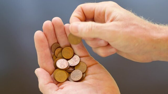 Man's hand counting euro cent coins