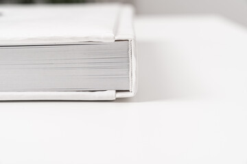 close-up of thick plastic pages white book in leather binding. photobooks.