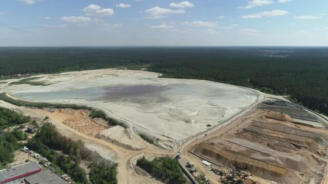 Aerial view of Huge sand dumps from a gold mine. Near the forest. A summer sunny day
