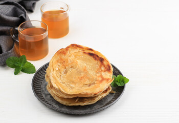 Middle East Canai or Paratha Flat Bread, or also known as Roti Maryam in Indonesia. Popular for Tajil Breakfasting. Isolated on White Background with Copy Space for Text