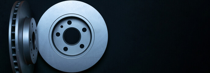 Silent blocks. New metal car part. Auto motor mechanic spare or automotive piece isolated on dark background. Automobile engine service with space for text.