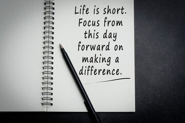 Motivational quote on notebook with dark background